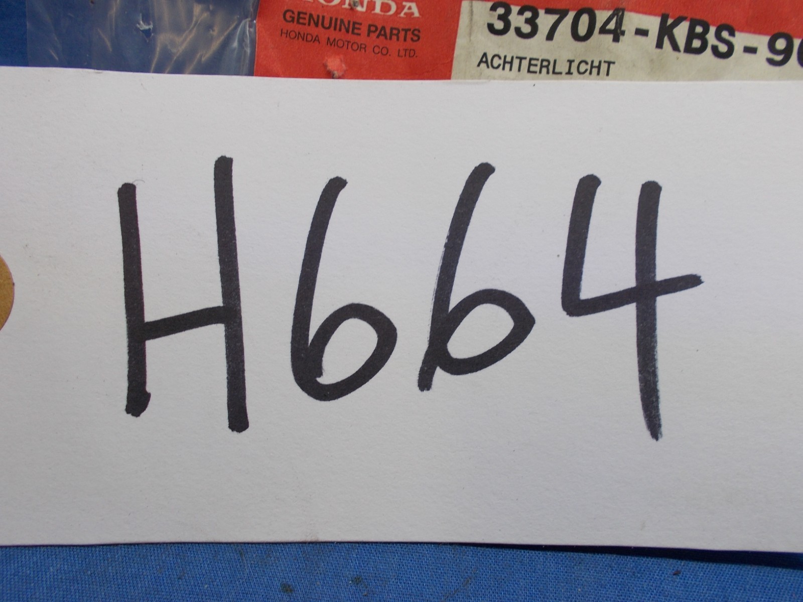 Honda 33704-KBS-900. OEM Tail Light Ornament. Fits Honda SFX50 SFX50MM.